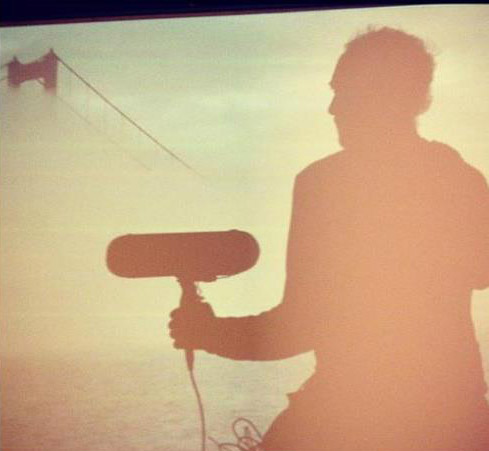 dreamy image of recordist holding microphone in front of the golden gate bridge